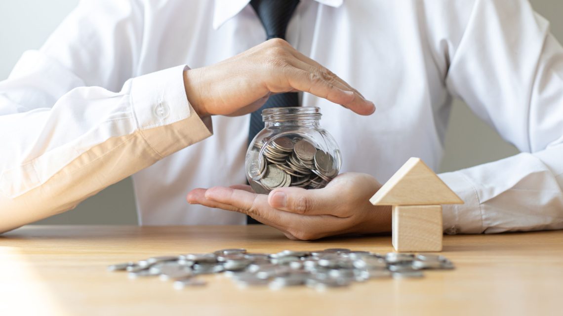 Landlord holding a glass jar of savings, symbolizing financial security and protection with landlord insurance.